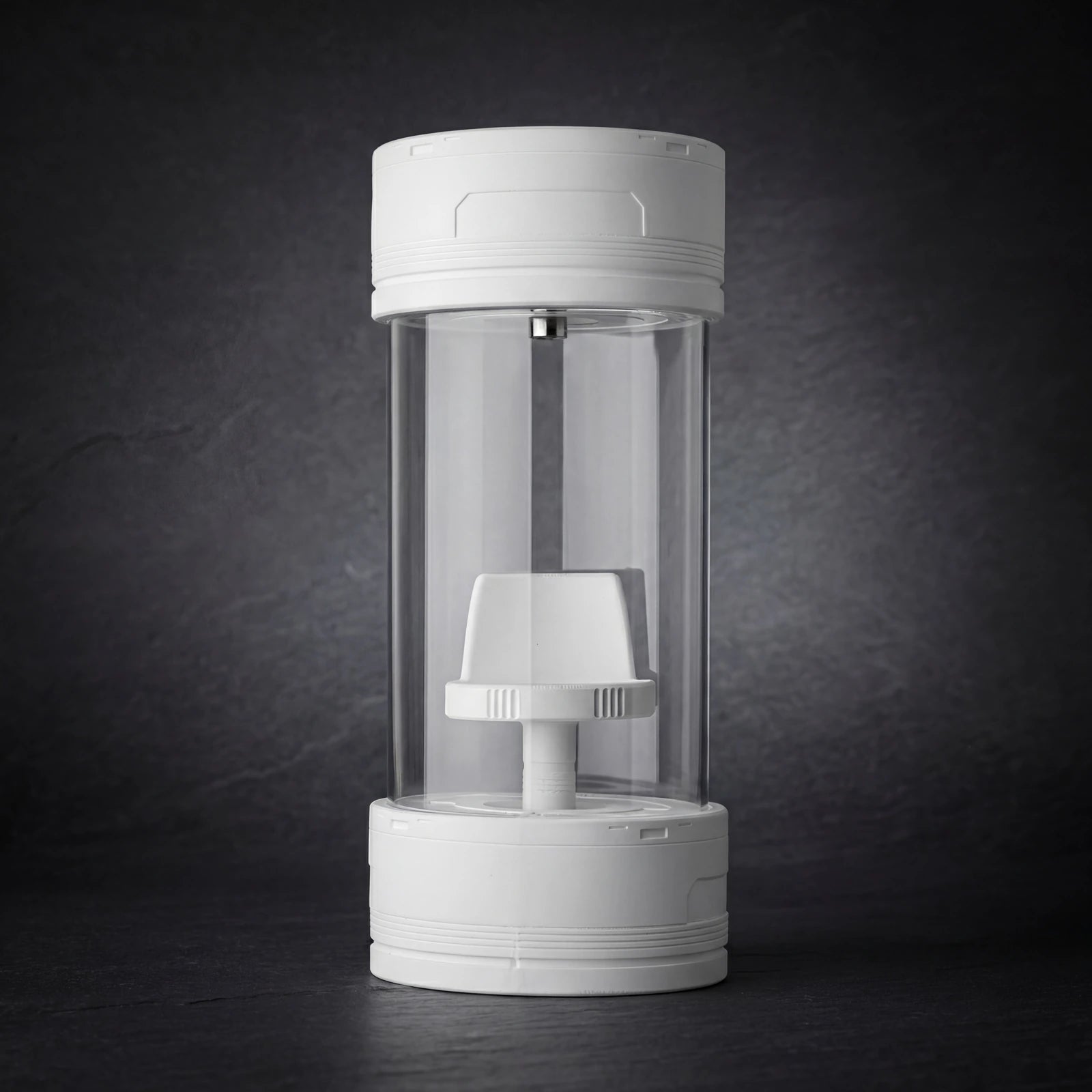 Empty cylindrical glass display case with upper light and raised stand