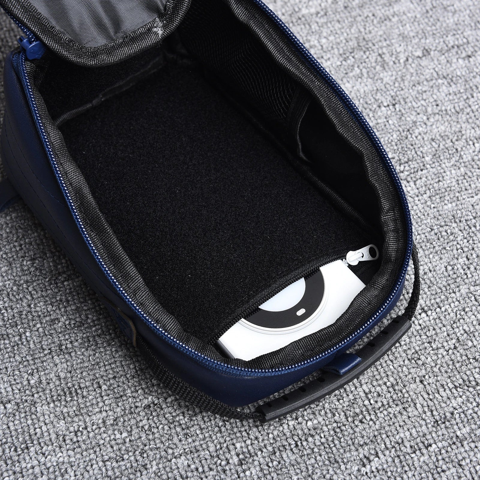 Open EDC organizer bag showing hook-and-loop interior and zip pocket