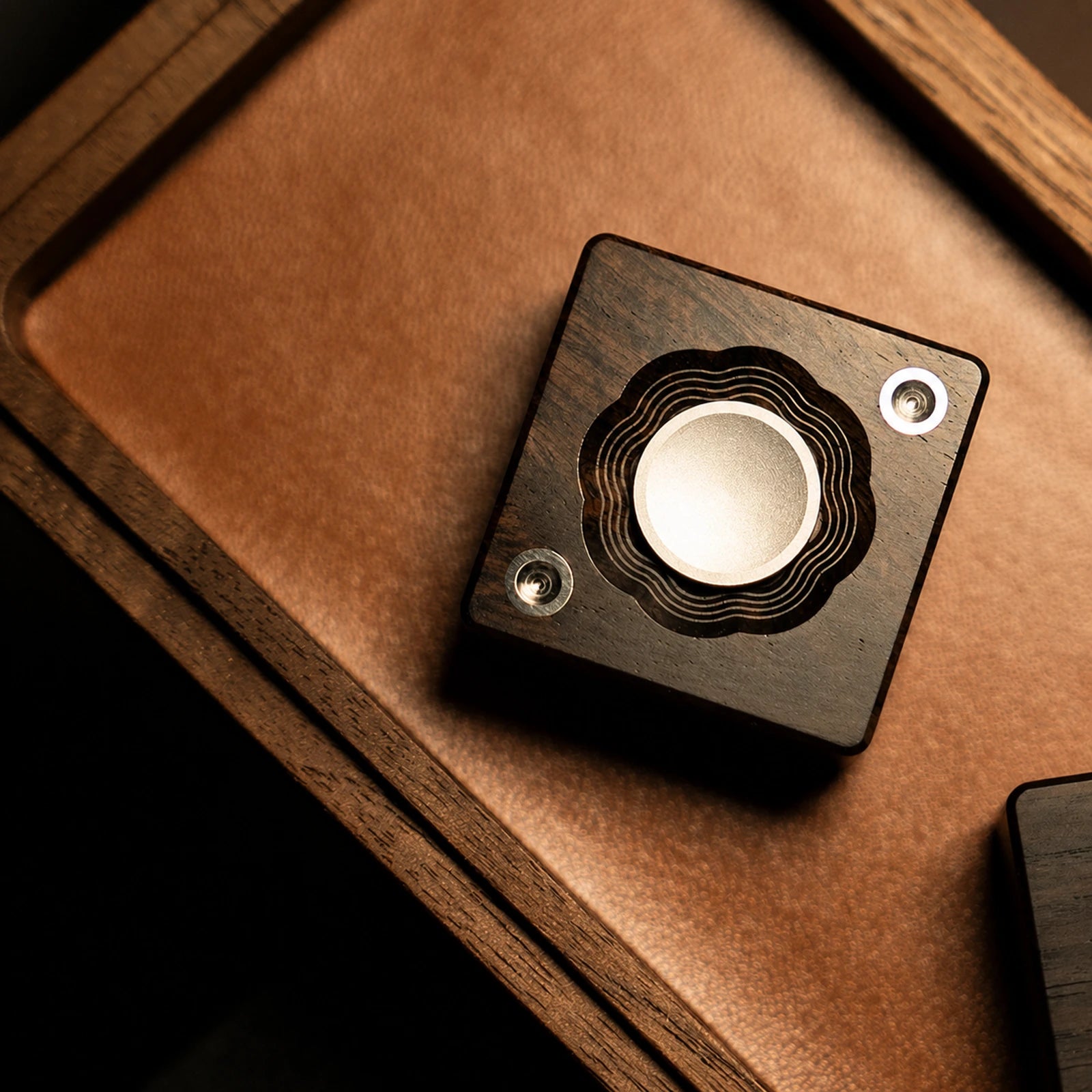 Mechanical ratchet fidget rotor with layered circular control on a wood tray