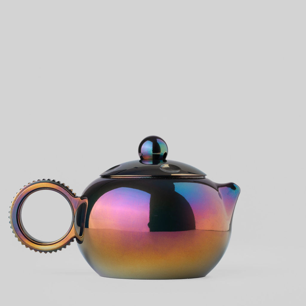 Zirconium teapot-shaped fidget toy with ring handle shown from the left
