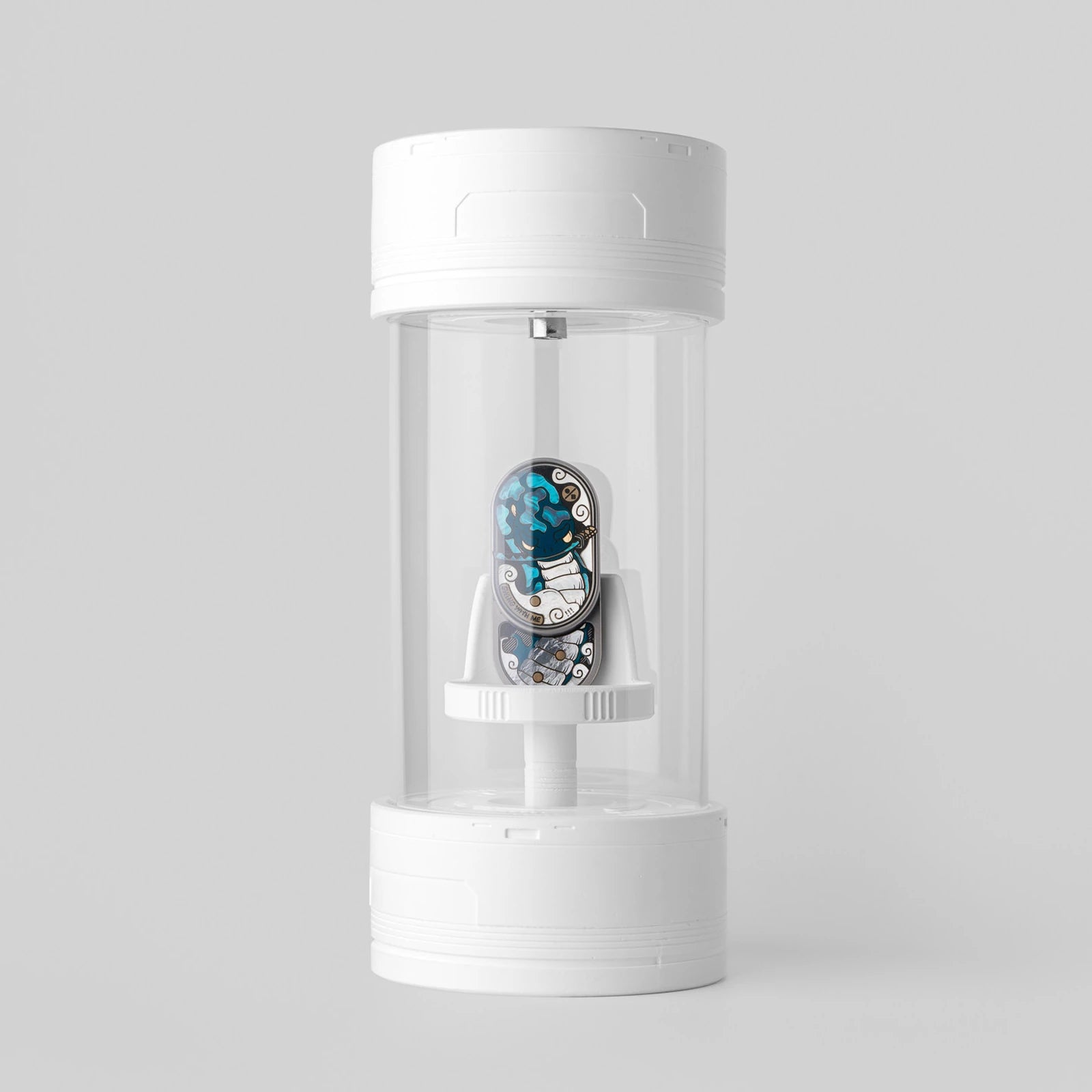 White cylindrical display case holding a colorful collectible example