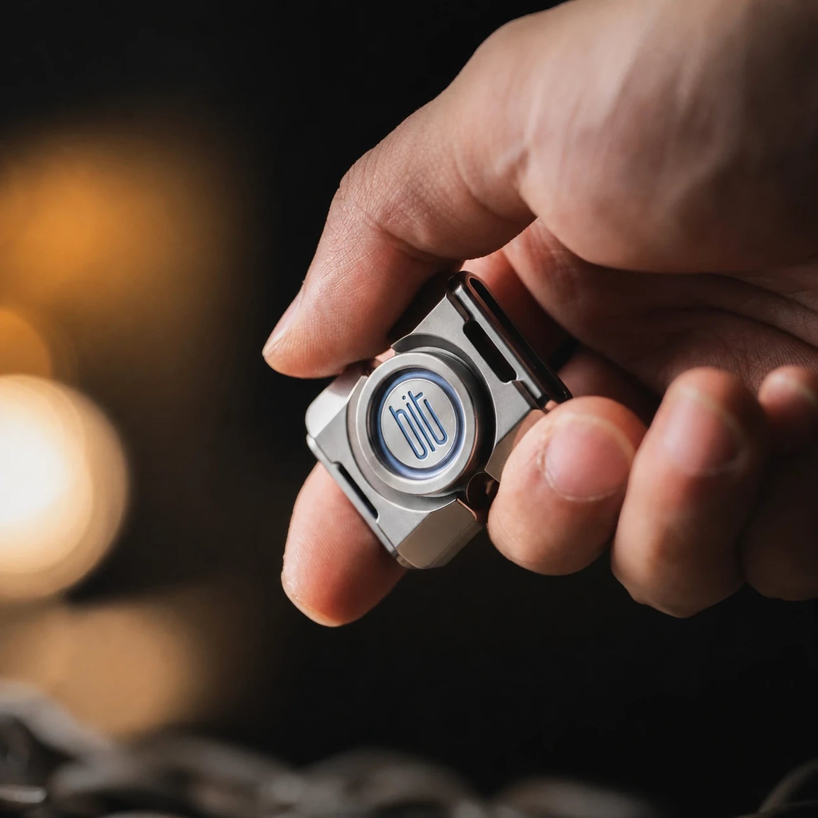 BIT-02 two-lobe fidget spinner held in one hand for scale
