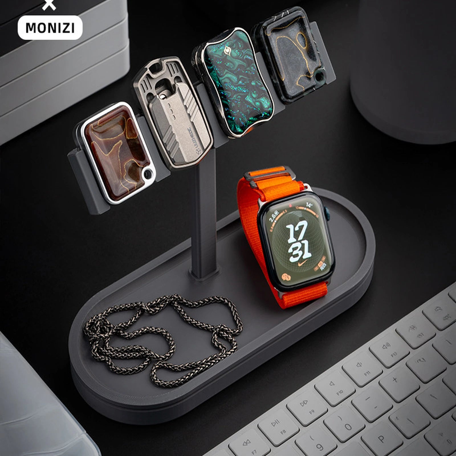 Dark gray pegboard display stand holding compact EDC pieces and a watch