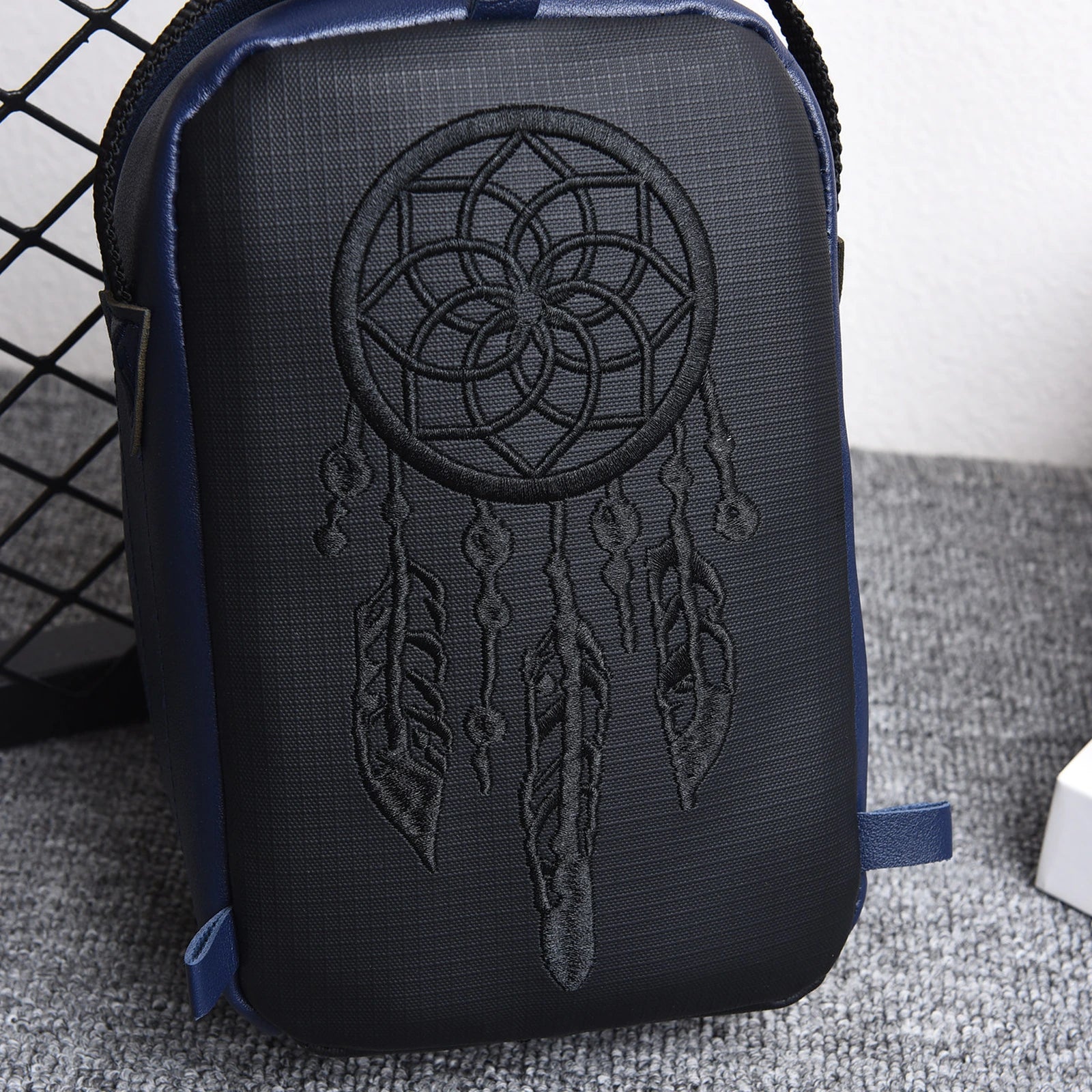 Front view of the compact EDC organizer bag with embroidered circular design