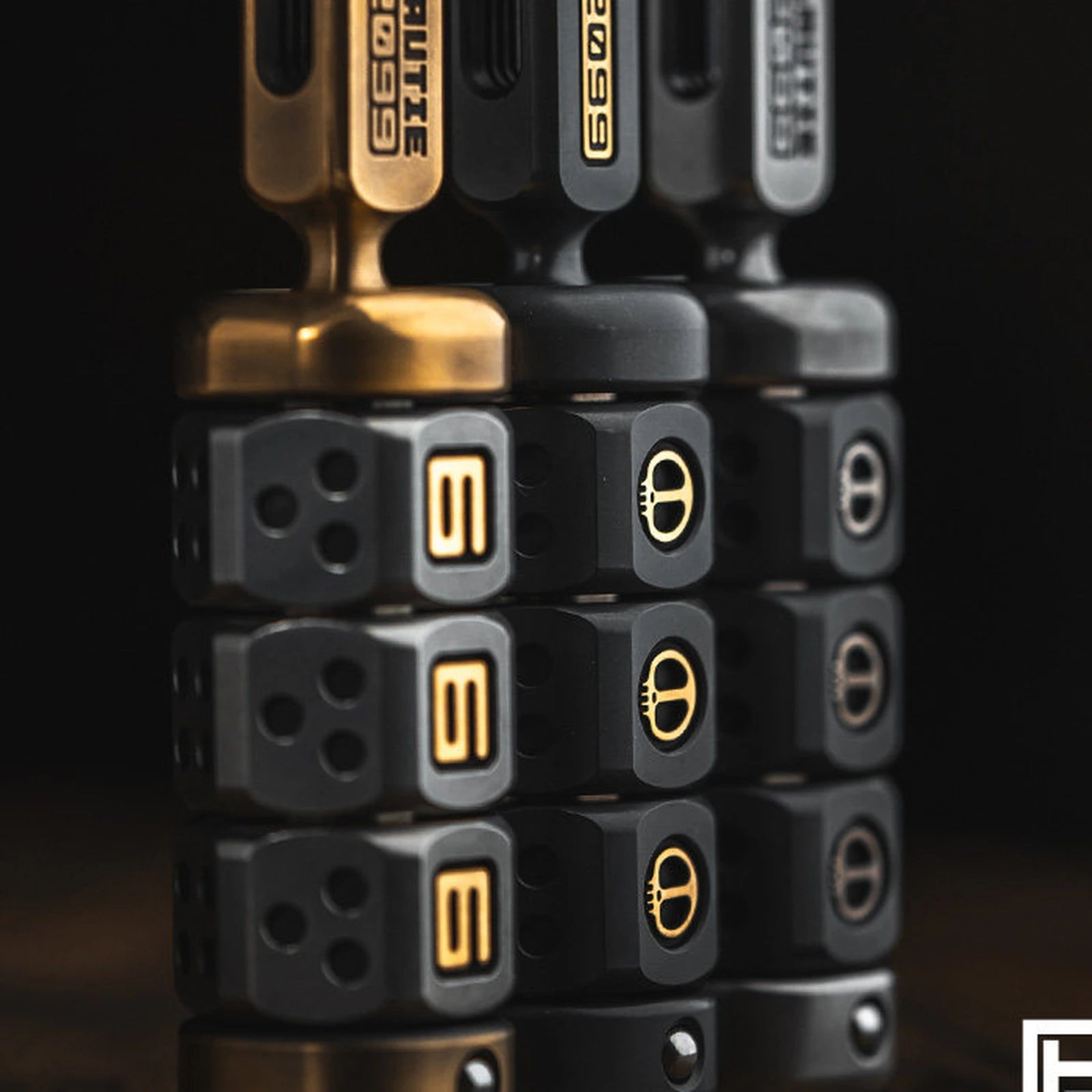 Three stacked rotating block fidget handles in contrasting finishes