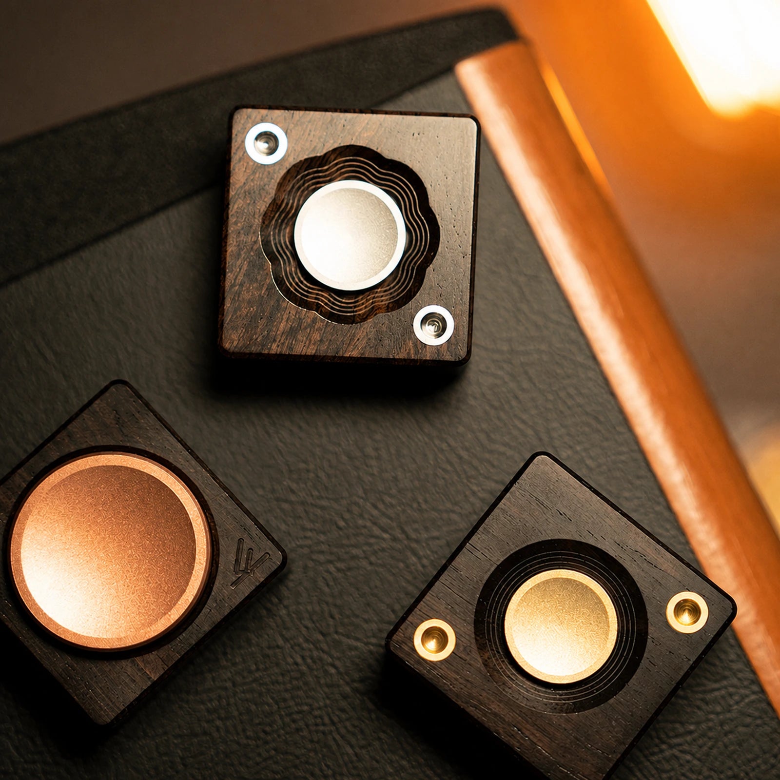 Three square mechanical fidget rotors with silver brass and copper controls