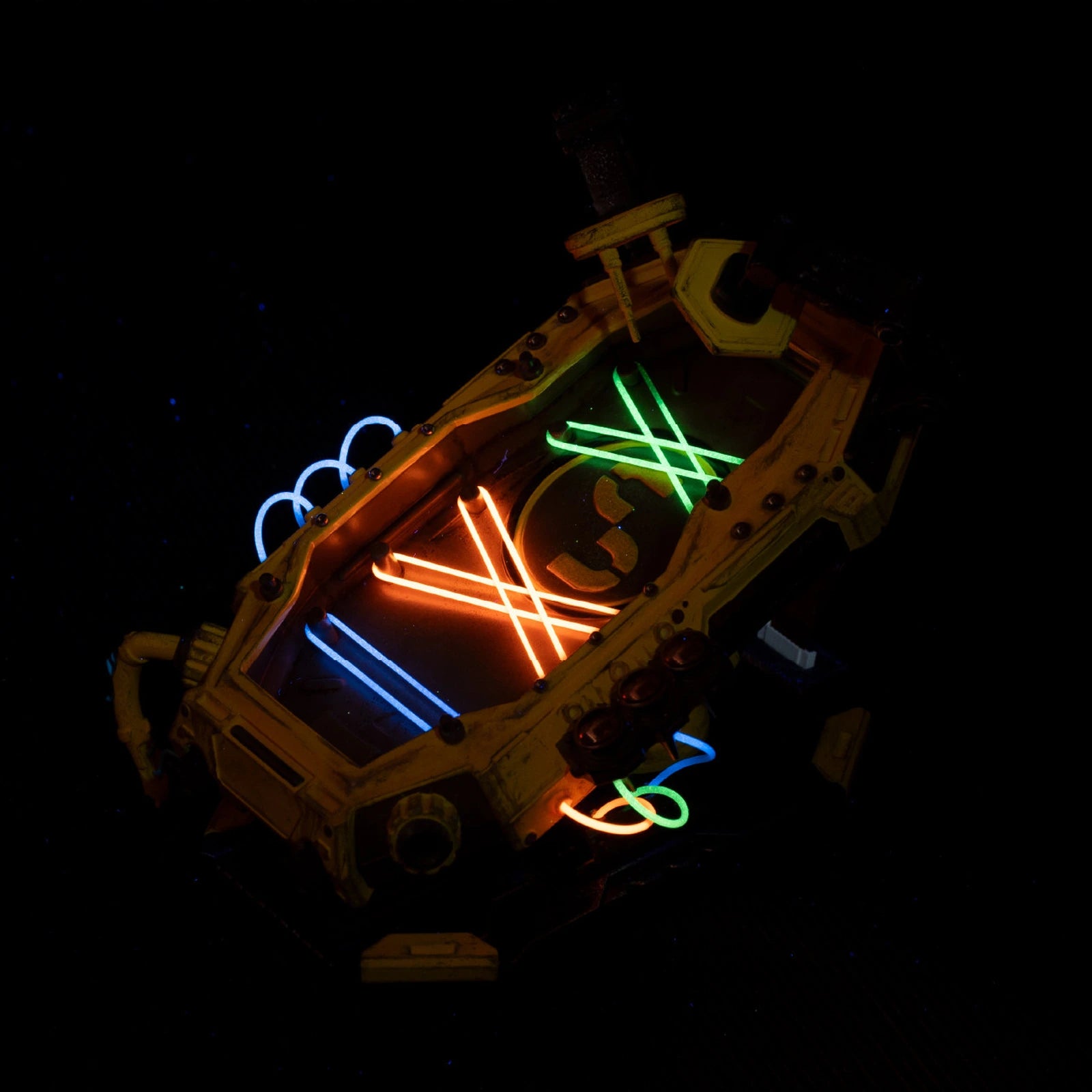 Mechanical EDC display stand showing colored luminous cords in low light