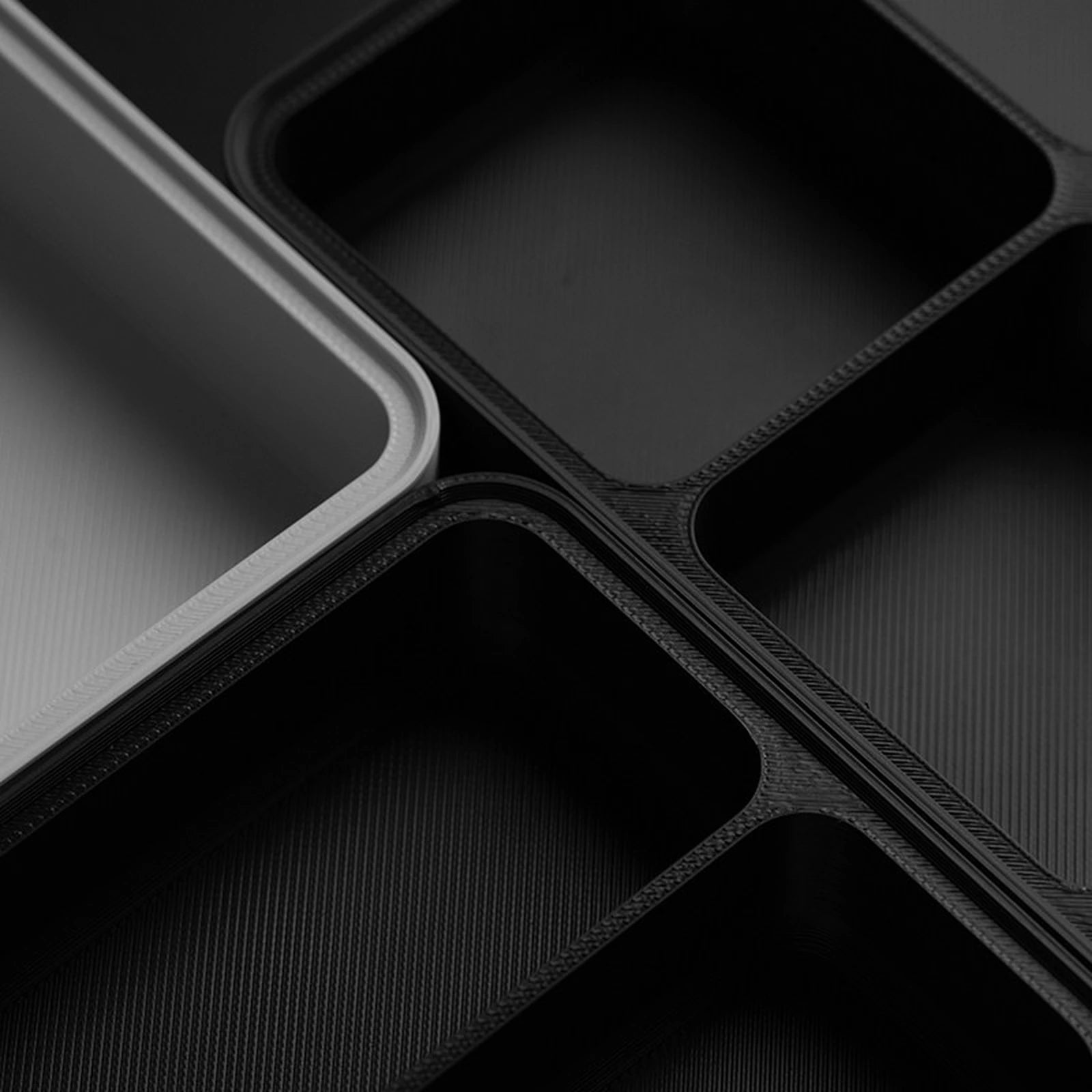Close-up view of textured black modular tray compartments