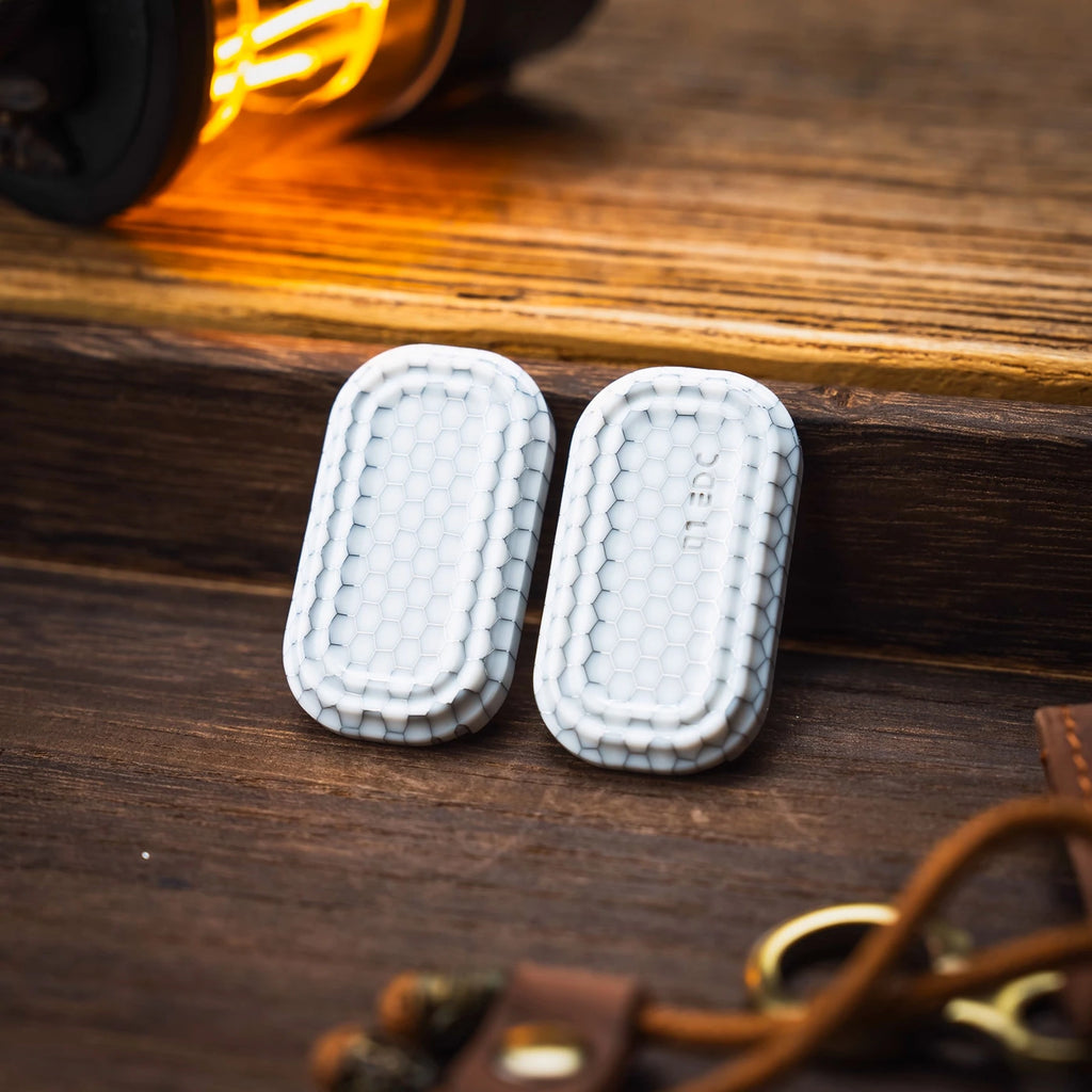 Two white honeycomb outer shells for the modular fidget slider