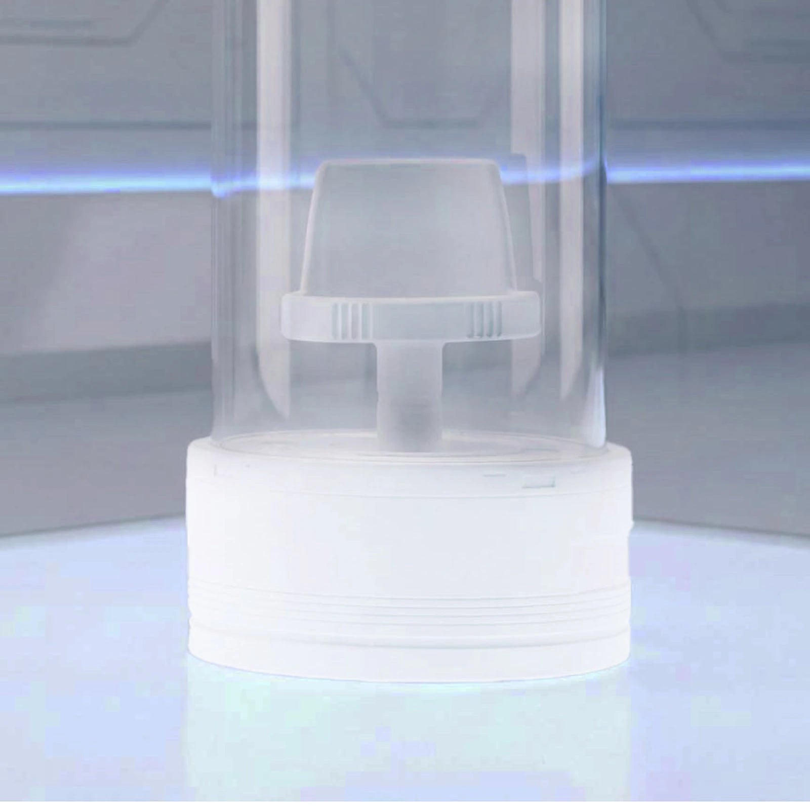 Close-up of the white display base illuminated on a desktop