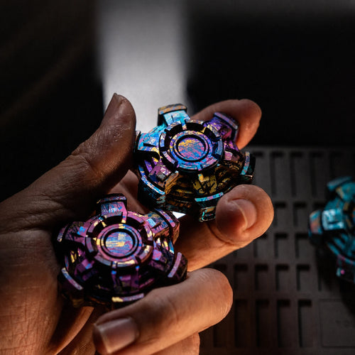 Two colorful articulated fidget spinners shown in a handheld view