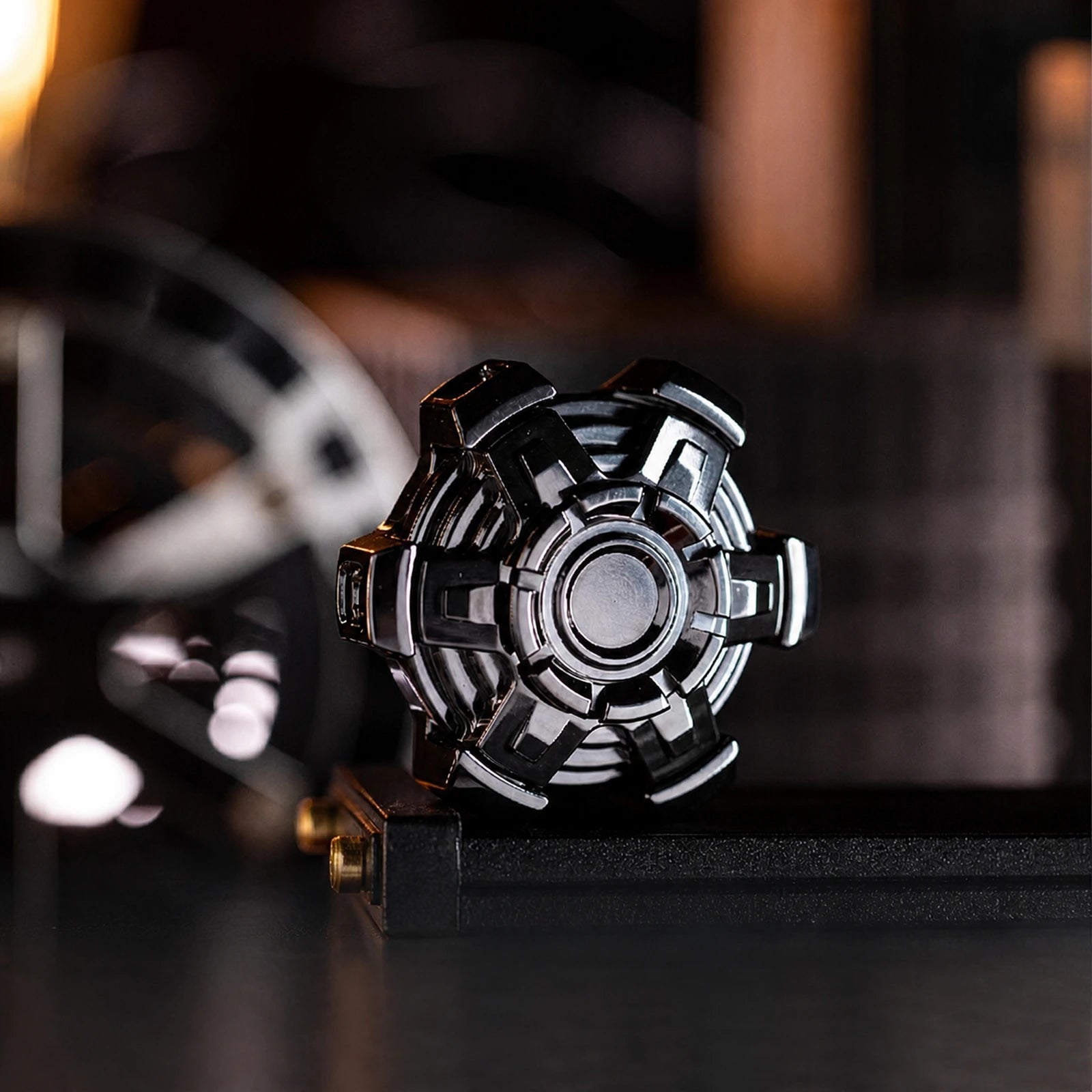 Black articulated fidget spinner displayed on a dark desktop